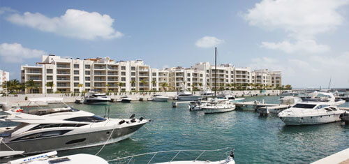 Picture of a beautiful marina in Cancun, Mexico.  The picture shows several fishing boats in the harbor.